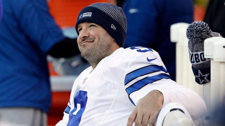 Dallas Cowboys' Tony Romo smiles on the bench during the...