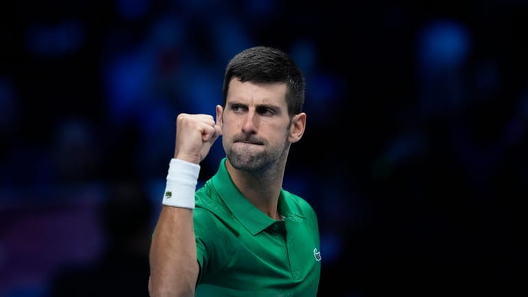 Serbia's Novak Djokovic celebrates after winning against Greece's Stefanos Tsitsipas...