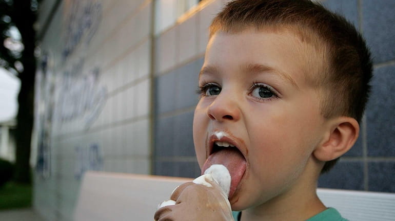Cohen Kosisky, 2, cools off with an ice cream cone...