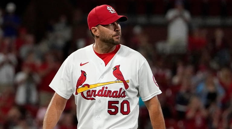 St. Louis Cardinals starting pitcher Adam Wainwright walks off the...