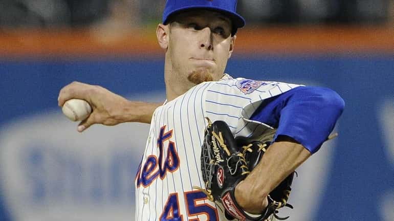 Zack Wheeler delivers a pitch during a game against the...