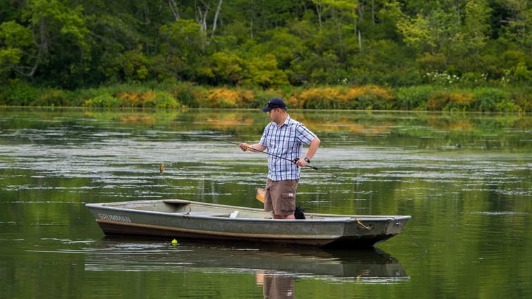 Fisherman on the lake at Suffolk County Blydenburgh Park was...