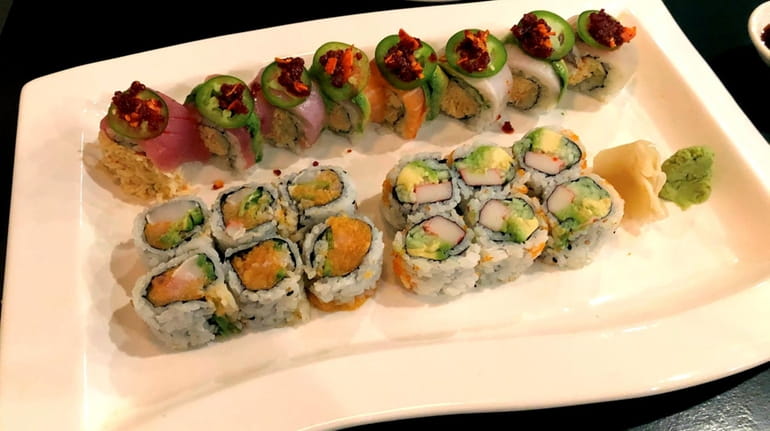 A chili rainbow roll with spicy crab, salmon, yellowtail and...