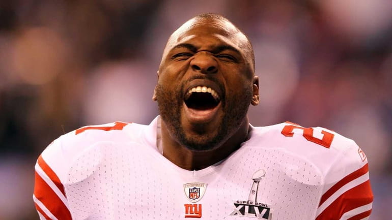 Brandon Jacobs screams as he warms up prior to playing...