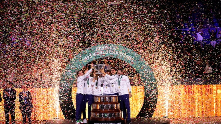 The Italian Davis Cup team celebrate with the trophy after...