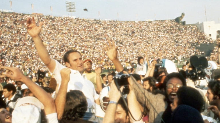 Miami Dolphins head coach Don Shula is carried off the...