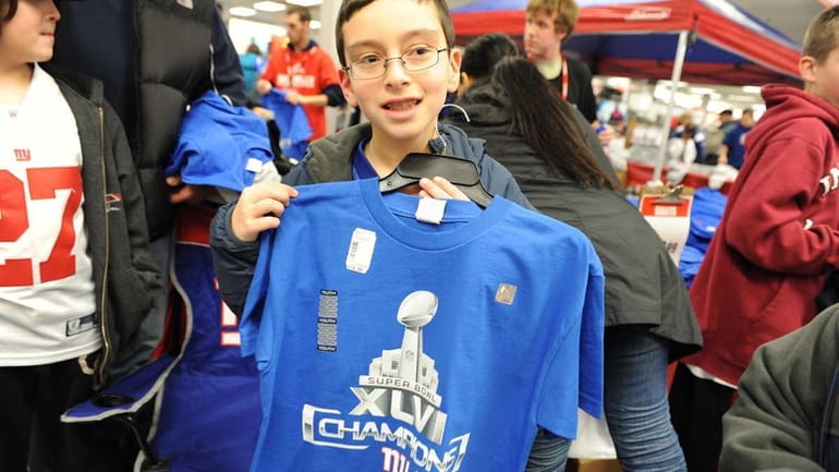 New York Giants fans grab Giants Superbowl XLVI Championship merchandise...