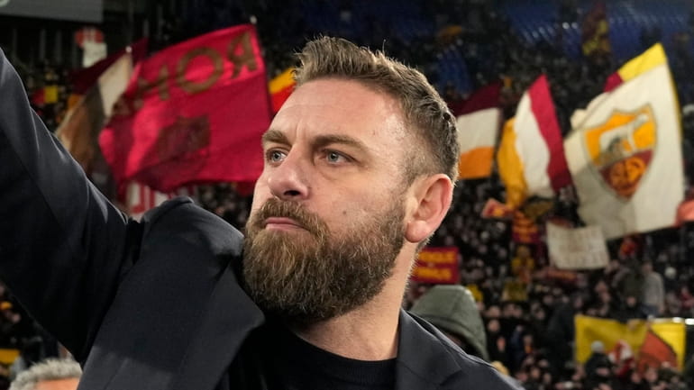 Roma's head coach Daniele De Rossi waves supporters at the...