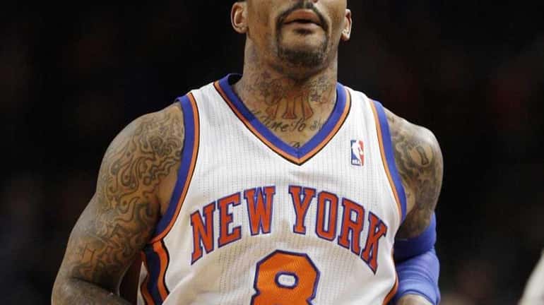 New York Knicks' J.R. Smith (8) reacts after making a...