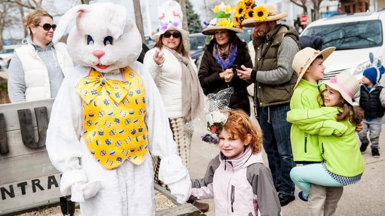 Freya Engdahl, from Brooklyn, holds the hand of the Easter...