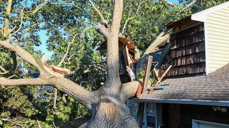 A Huntington Station home damaged by a tree during the Tuesday...