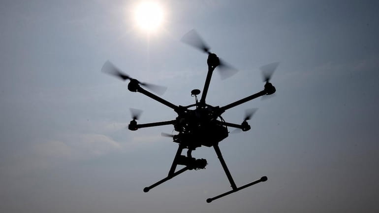 In this June 11, 2015 file photo, a hexacopter drone...