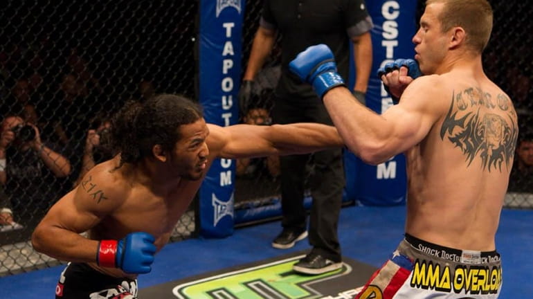 Ben Henderson, left, successfully defended his lightweight title against Donald...