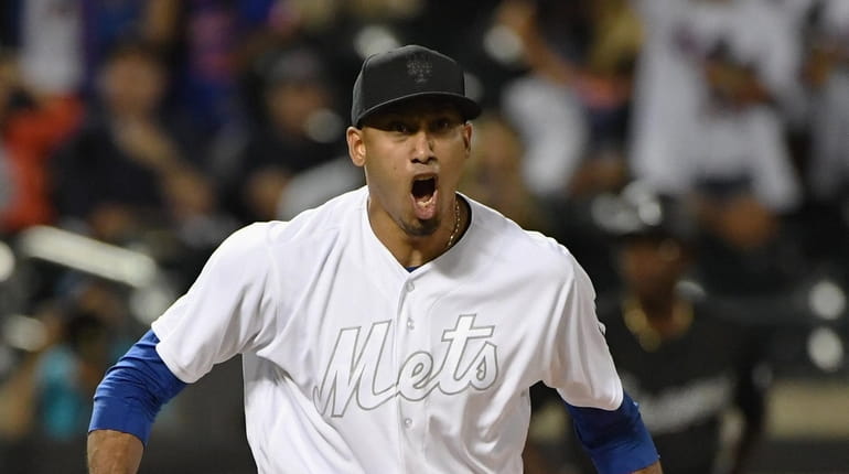 Mets relief pitcher Edwin Diaz reacts after he strikes out...