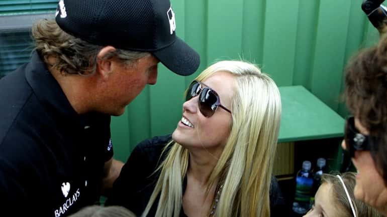 Phil Mickelson celebrates with his wife Amy after winning the...
