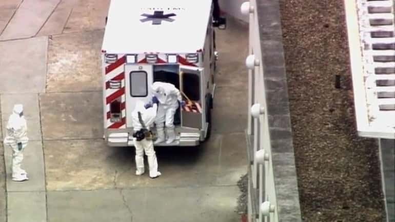 An ambulance arrives with Ebola victim Dr. Kent Brantly, right,...