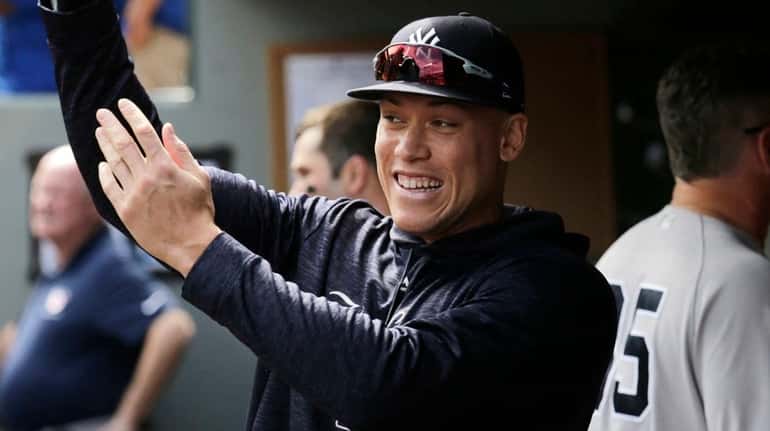 The Yankees' Aaron Judge shares a laugh with teammates in...
