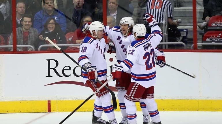Carl Hagelin of the New York Rangers celebrates with teammates...