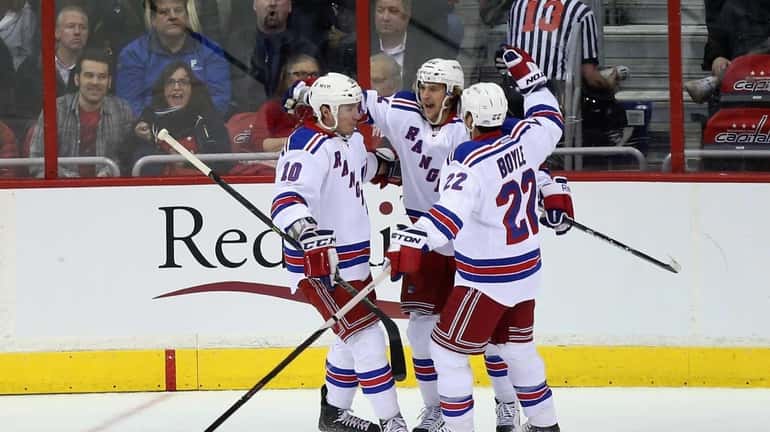 Carl Hagelin of the New York Rangers celebrates with teammates...