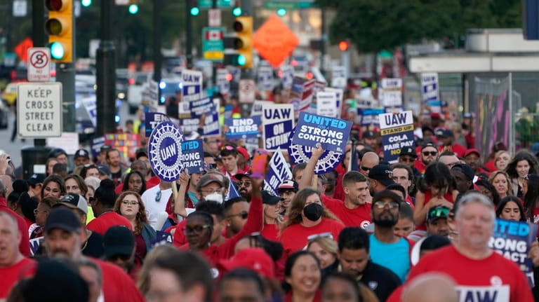 United Auto Workers members march through downtown Detroit, Friday, Sept....