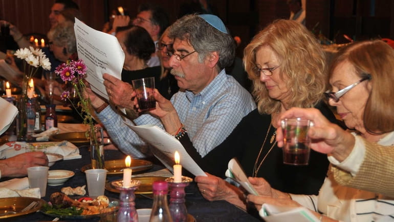 Carol Feig, center, with husband Bill, left, celebrate Passover at...