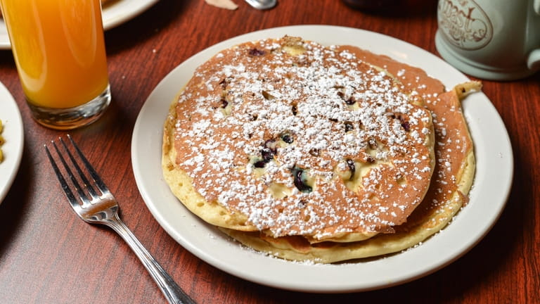 Blueberry pecan pancakes dusted with powdered sugar at Toast Coffeehouse.