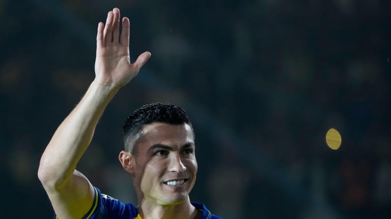 Cristiano Ronaldo greets Saudi fans during his official unveiling as...