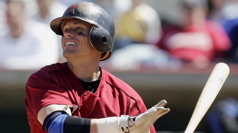 Craig Biggio watches the flight of a hit in a...