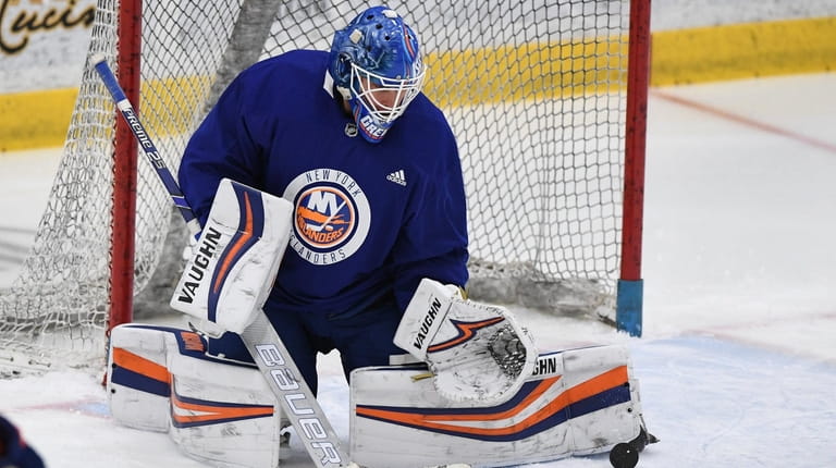 Islanders goaltender Thomas Greiss makes a pad save during hockey...