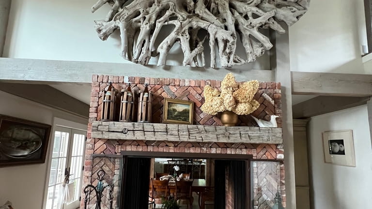 The fireplace in Kenneth B. Zahler's Greenport home incorporates bricks...