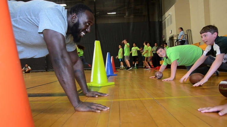 New York Jets defensive lineman Muhammad Wilkerson works out with...