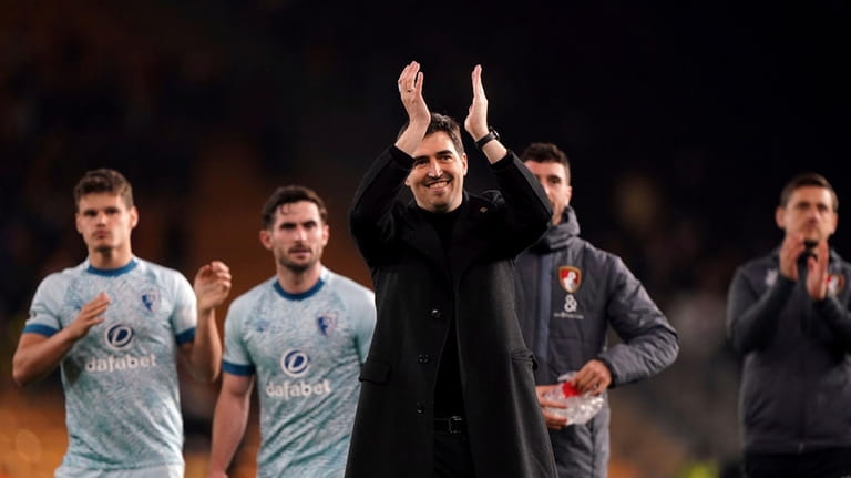 Bournemouth manager Andoni Iraola,front, applauds after the English Premier League...