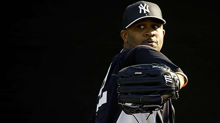 Yankees pitcher CC Sabathia pitches in the bullpen at practice...