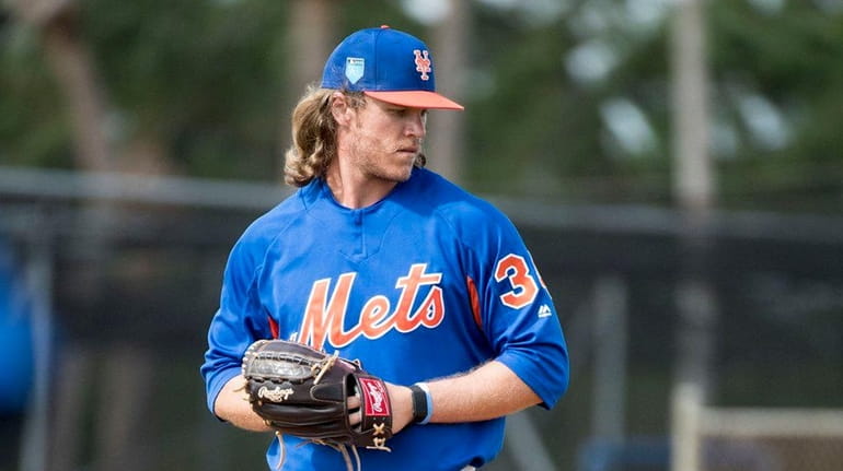 Mets pitcher Noah Syndergaard throws during a spring training workout...