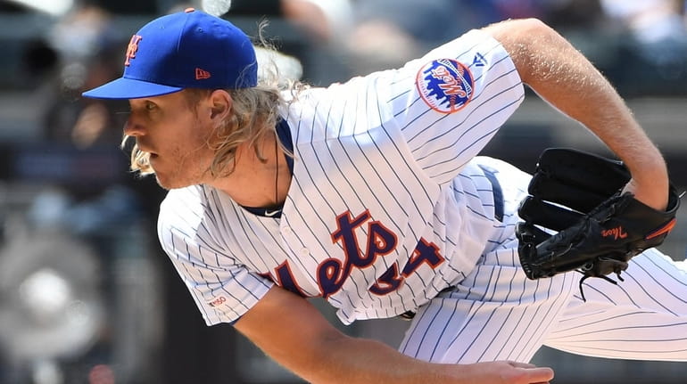 New York Mets starting pitcher Noah Syndergaard delivers against the...
