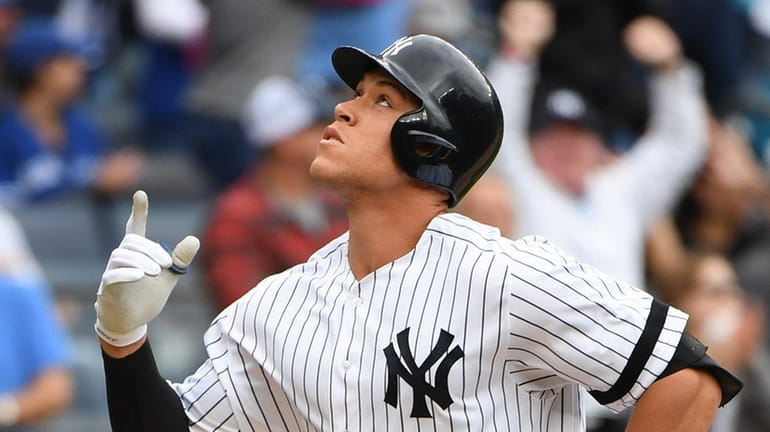 New York Yankees designated hitter Aaron Judge reacts as he...