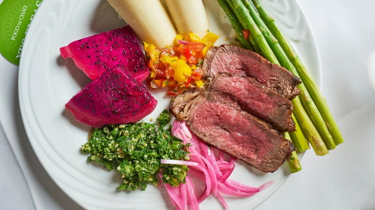Sliced Wagyu steak with pickled onions, hearts of palm, and...