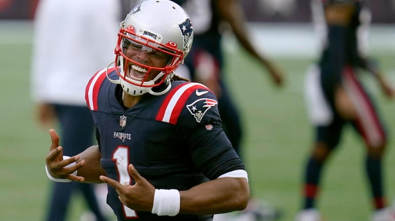 New England Patriots quarterback Cam Newton celebrates after defeating the...