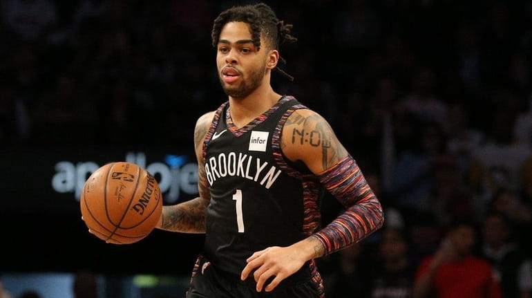 Nets point guard D'Angelo Russell brings the ball upcourt against...