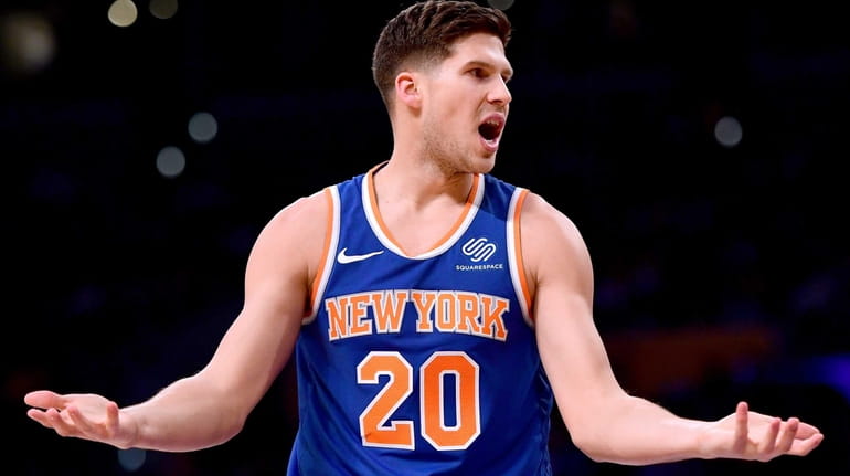 Doug McDermott #20 of the New York Knicks reacts to...