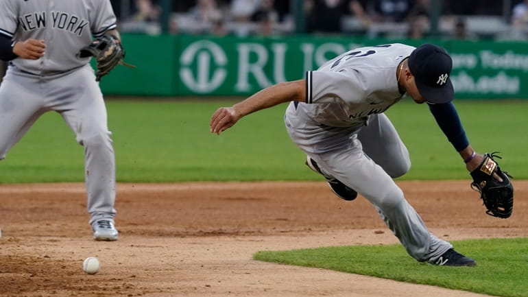 Yankees shortstop Isiah Kiner-Falefa, right, cannot make the play on...