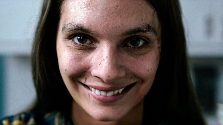 Caitlin Stasey grins it up in a scene from "Smile."