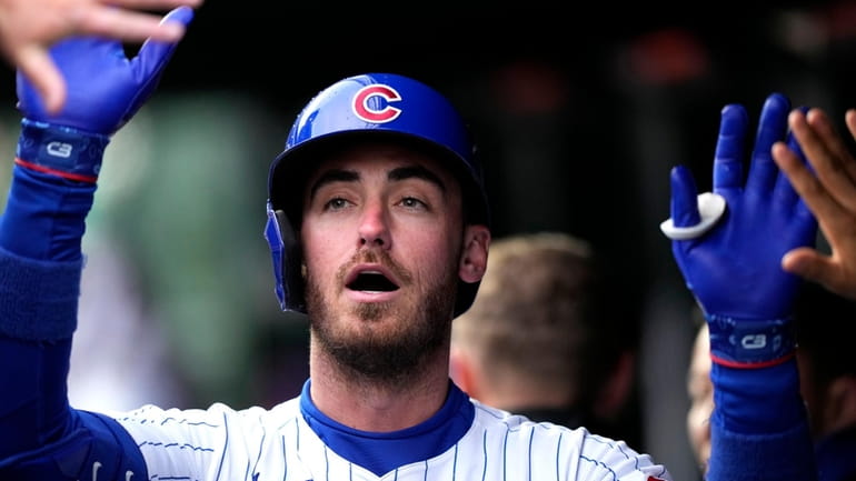 Chicago Cubs' Cody Bellinger celebrates with teammates after hitting a...
