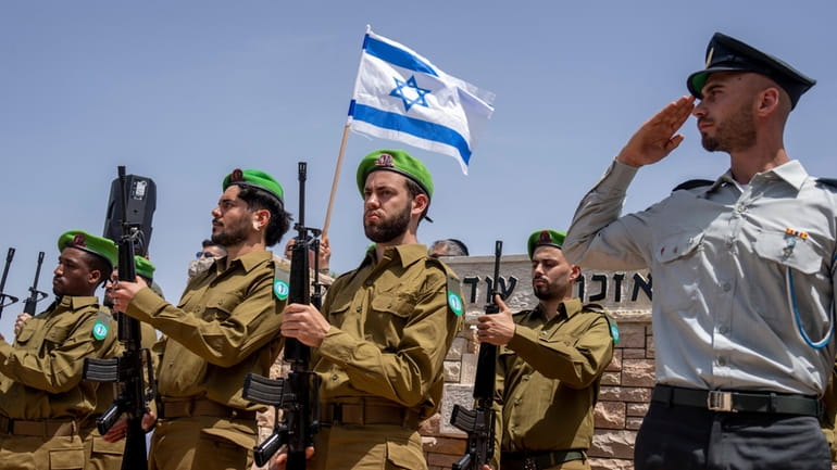 Israeli honor guard soldiers salute during the funeral Israeli reserve...