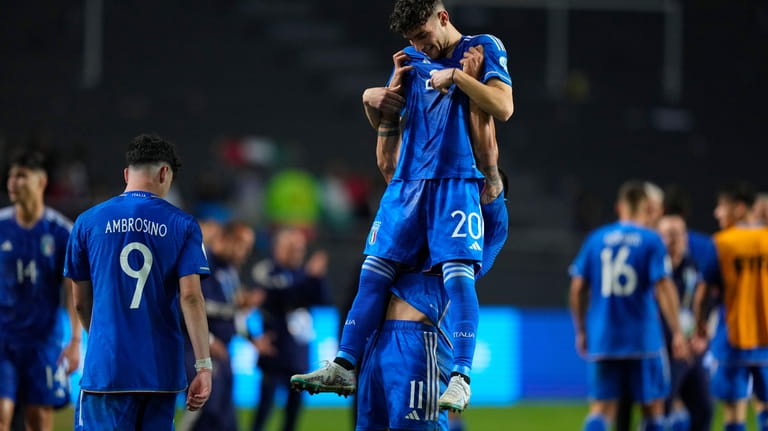 Players of Italy celebrate their team's win over South Korea...