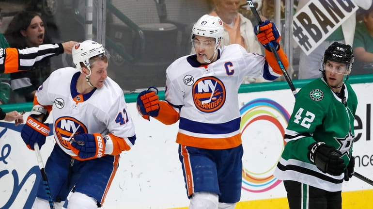 New York Islanders left wing Anders Lee (27) and right...
