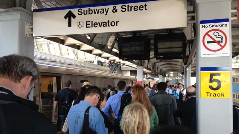 Commuters wait at Jamaica station in Queens for Long Island...