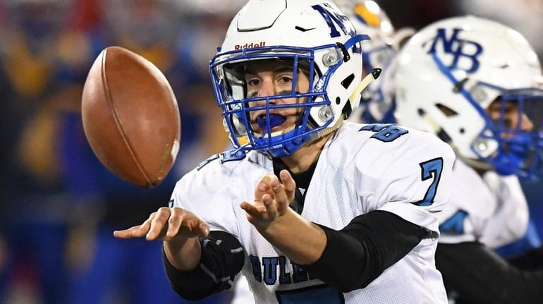 North Babylon quarterback Ross Tallarico pitches the ball against West...