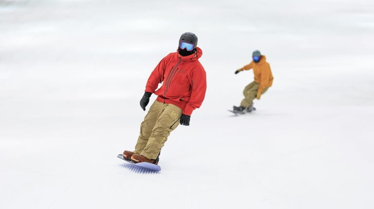 Snowboarders glide down the "Big SNOW" indoor ski run, found...
