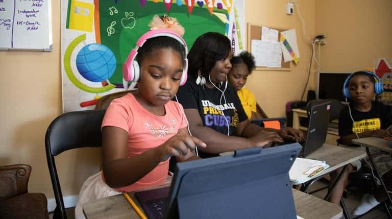 Ebony Guerrier works with her children Madison, 6, Ryana,12, and Destin,...
